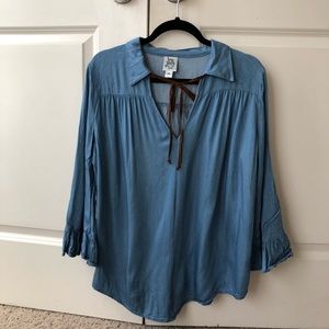 Blue top with brown tie